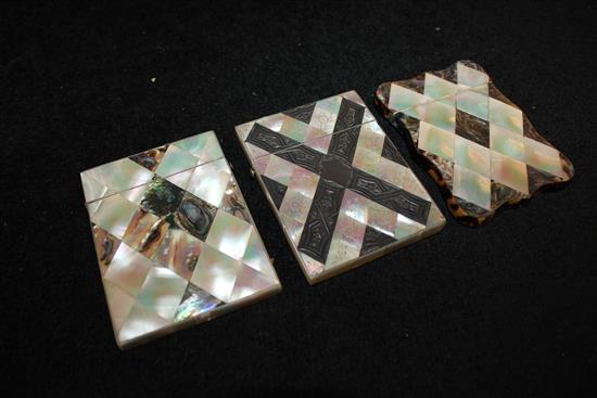 Two abalone and mother of pearl card cases (one tortoiseshell-edged) & a white metal-inlaid engraved mother of pearl case(-)